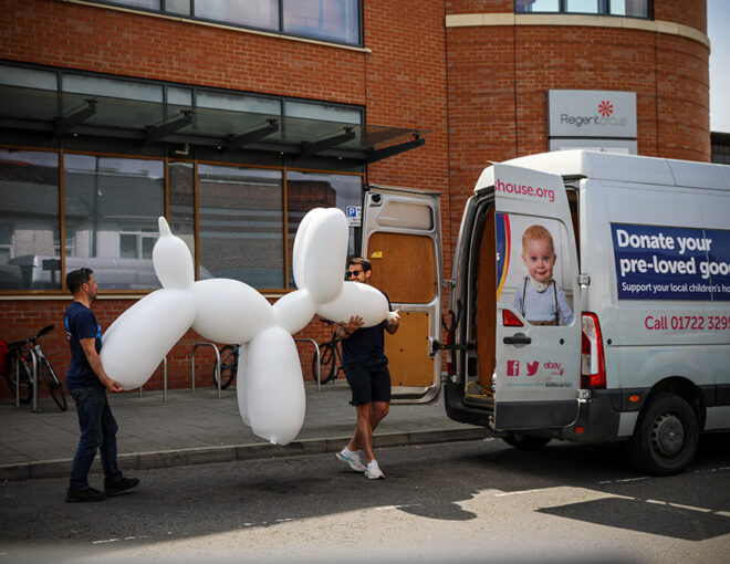 Balloon dog being carried into the van